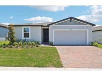 Charming single-story home with a well-manicured lawn and a brick driveway, offering great curb appeal at 2365 White Tail St, Davenport, FL 33837