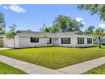 Charming single-story home with a well-maintained lawn and fresh white exterior paint at 2601 Telstar Ave, Orlando, FL 32805