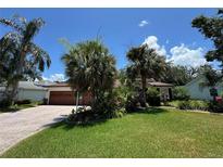 Charming single-story home features lush landscaping and a well-maintained lawn at 3807 Plantation Blvd, Leesburg, FL 34748