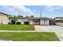 Charming single-story home with a well-maintained front yard and brick pathway leading to the front door at 4629 Spottswood Dr, Orlando, FL 32812
