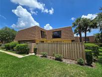 Charming townhome featuring a unique roof, fenced yard, and lush landscaping at 5288 Cypress Ct # 439, Orlando, FL 32811