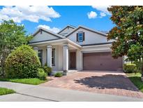 Charming home featuring a two-car garage and well-maintained landscaping at 8713 Iron Mountain Trl, Windermere, FL 34786