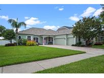 Charming single-story home with a well-manicured lawn, a brick driveway, and inviting curb appeal at 13838 Bluebird Park Rd, Windermere, FL 34786