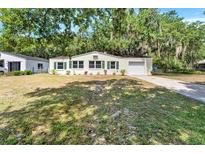 Charming single-story home with a well-maintained lawn, green shutters, and a one-car garage at 1506 S Elliott St, Sanford, FL 32771