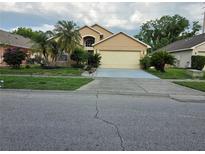 Charming single-story home featuring lush landscaping and a welcoming two-car garage at 1797 Tillstream Dr, Orlando, FL 32818