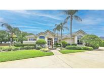 Stunning single-story home with meticulously landscaped front yard, fountain, and palm trees at 204 Quail Trail Ct, Lake Mary, FL 32746