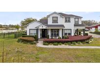 Charming two-story home with landscaped yard and elegant monochrome color palette at 3201 Dallas Blvd, Orlando, FL 32833