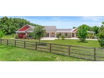 Charming home with a large front yard and decorative wooden fence at 700 Old Geneva Rd, Geneva, FL 32732