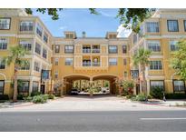 Beautiful multi-story building with a grand entryway and lush landscaping at 860 N Orange Ave # 210, Orlando, FL 32801