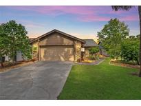 Charming home featuring stone accents, a well-manicured lawn, and a spacious driveway, offering classic curb appeal at 110 Todd Dr, Casselberry, FL 32707