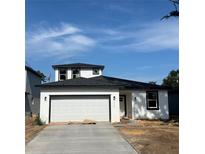 Newly constructed two-story home with a modern design and a spacious two-car garage at 230 Lucile Way, Orlando, FL 32835