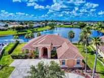 Expansive home featuring lake view, mature landscaping, and a grand front entrance, promising luxurious living at 3728 Hunters Isle Dr, Orlando, FL 32837
