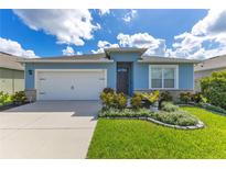 Charming single-story home featuring a well-manicured lawn, attached garage, and delightful curb appeal at 633 Greymount St, Davenport, FL 33837