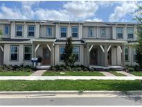 Charming townhome featuring a well-manicured lawn and inviting front porches, perfect for relaxing outdoors at 6331 Breeze Filled Ln, Winter Garden, FL 34787