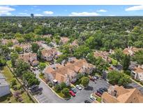 An aerial view of a residential community with lush green trees and well-maintained townhomes at 645 Stafford Ter # 163, Altamonte Springs, FL 32714
