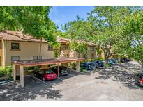 A well maintained apartment complex with mature landscaping, covered parking, and a terracotta tile roof at 1217 Salerno Ct # 1217, Orlando, FL 32806