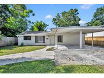 Charming single-story home with a carport, walkway, and lush lawn at 1308 Oregon St, Orlando, FL 32803