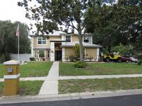 Charming two-story home features manicured lawn, mature trees, and a welcoming front entrance at 1420 Center St, Ocoee, FL 34761