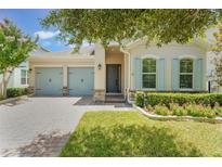 Charming single-story home with a well-manicured lawn, two-car garage and stone accents at 15424 Sweet Orange Ave, Winter Garden, FL 34787