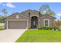 Charming single-story home with a well-maintained lawn, landscape, and a welcoming front porch at 17485 Sw 36Th Ter, Ocala, FL 34473