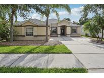 Charming single-story home with a well-manicured lawn and a large driveway leading to the front entrance at 2315 Black Lake Blvd, Winter Garden, FL 34787