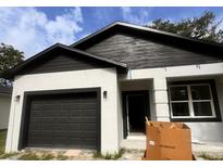 Charming single Gathering house with a garage and modern black and white paint job at 2352 Ross St, Kissimmee, FL 34744