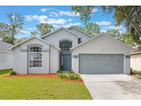 Charming single-Gathering home featuring a two-car garage, arched windows and landscaped front yard at 2767 Aragon Ter, Lake Mary, FL 32746