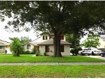Charming home featuring a well-manicured lawn and mature trees providing ample shade at 3017 Lambath Road, Orlando, FL 32818