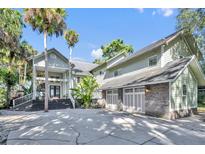 Stunning two-story home featuring a three-car garage and inviting front entry with well-manicured landscaping at 419 Whitcomb Dr, Geneva, FL 32732