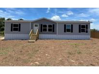 Charming single-story home featuring a neutral color scheme and black window shutters at 4720 Oak St, Fruitland Park, FL 34731