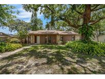 Charming single-story home with a well-maintained lawn and mature trees providing ample shade at 525 Garden Heights Dr, Winter Garden, FL 34787
