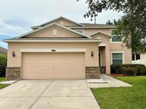 Charming two-story home with a two-car garage and manicured lawn at 5917 Coquyt Dr, Mount Dora, FL 32757