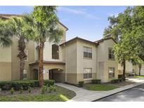 Inviting condo building featuring lush landscaping and a well-maintained exterior with beautiful palm trees at 829 Camargo Way # 211, Altamonte Springs, FL 32714