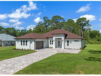 Beautiful single-story home with a brick paver driveway and a well-manicured lawn at 10 Dial Ave, Debary, FL 32713