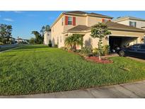 Well maintained two-story home featuring a lush green lawn and manicured landscaping at 1259 Pando Loop, Orlando, FL 32824