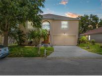 Charming two-story home features lush landscaping and a large two-car garage at 1905 Emily Blvd, Winter Haven, FL 33884