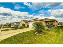 Charming single-Gathering home with a well-manicured lawn, driveway, and pleasing landscaping at 2932 Whispering Trails Dr, Winter Haven, FL 33884
