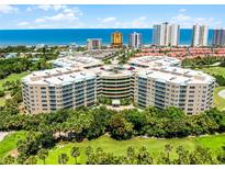 Stunning aerial view of a beachfront condo complex with lush landscaping and ocean views on a sunny day at 4 Oceans West Blvd # 502D, Daytona Beach Shores, FL 32118