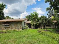 Charming single-story home with stone facade and mature landscaping at 4415 Raymar Dr, Orlando, FL 32839