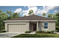 Charming single-story home with neutral exterior, well-maintained lawn, and attached two-car garage at 7415 Sandstone Dr, Groveland, FL 34736