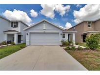Inviting home exterior featuring a well-manicured lawn, covered entryway, and a spacious driveway at 8618 Sw 46Th Ave, Ocala, FL 34476