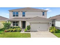 Charming two-story home featuring a two-car garage and well-maintained landscaping at 9024 Alba Ln, Kissimmee, FL 34747