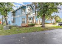Charming two-story light blue condo with brick accents and beautiful landscaping at 2727 N Poinciana Blvd # 134, Kissimmee, FL 34746