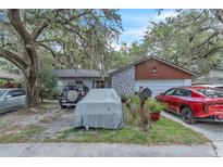 Charming single-Gathering home featuring stone accents and a well-maintained front yard at 10359 Smyrna Dr, Orlando, FL 32817