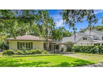 Charming single story home with mature landscaping, porte-cochere, and well-maintained lawn at 1606 Orangewood Ave, Orlando, FL 32806