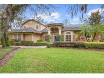 Beautiful two-story home featuring manicured landscaping and mature trees in a well kept yard at 1689 Wingspan Way, Winter Springs, FL 32708