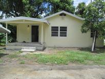 Charming single-story home with a covered porch entry, complemented by a lush green yard at 2112 Lee St, Orlando, FL 32805