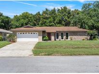 Charming single-story home featuring a two-car garage and well-manicured lawn at 2151 Conifer Ave, Winter Park, FL 32792