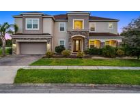 Stunning two-story home featuring a stone facade, well-manicured lawn, and a spacious two-car garage at 2275 Pearl Cider St, Orlando, FL 32824