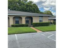 Charming single-story home with well-maintained lawn, complemented by a tree and paved parking at 228 Everest Pt # 108, Casselberry, FL 32707